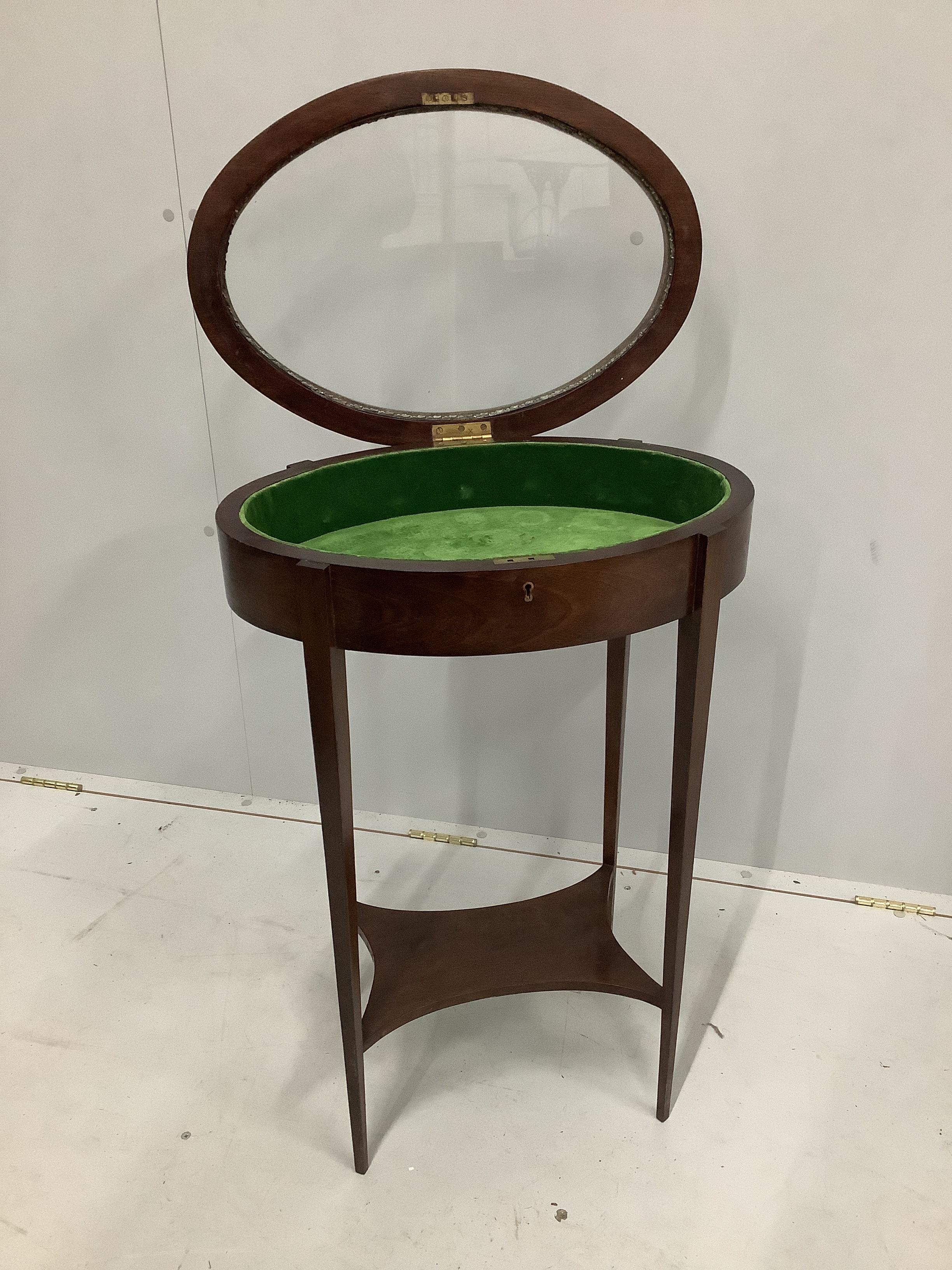 An Edwardian style oval mahogany bijouterie table, width 52cm, depth 36cm, height 75cm